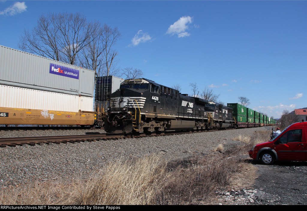 NS 4428 and 1811 take train 257 down the siding as 26X passes on main 1